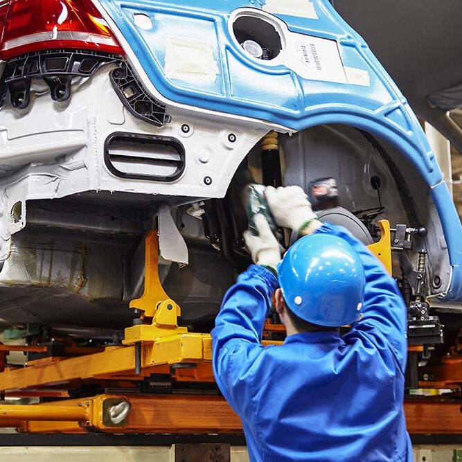 Shanghai, China, China - January 12, 2016: Workers are installing car chassis firmware on the production line of the Shanghai Volkswagen manufacturing workshop